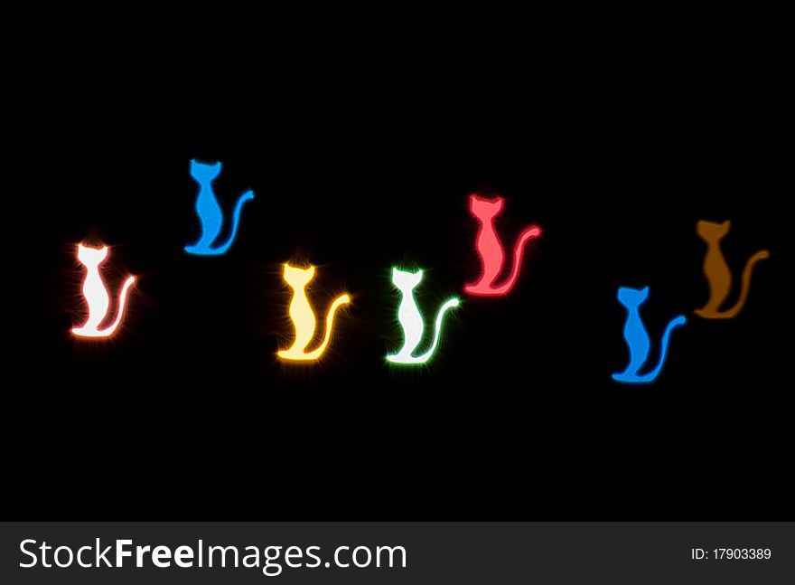 Light effect in the form of cats on black background. Light effect in the form of cats on black background