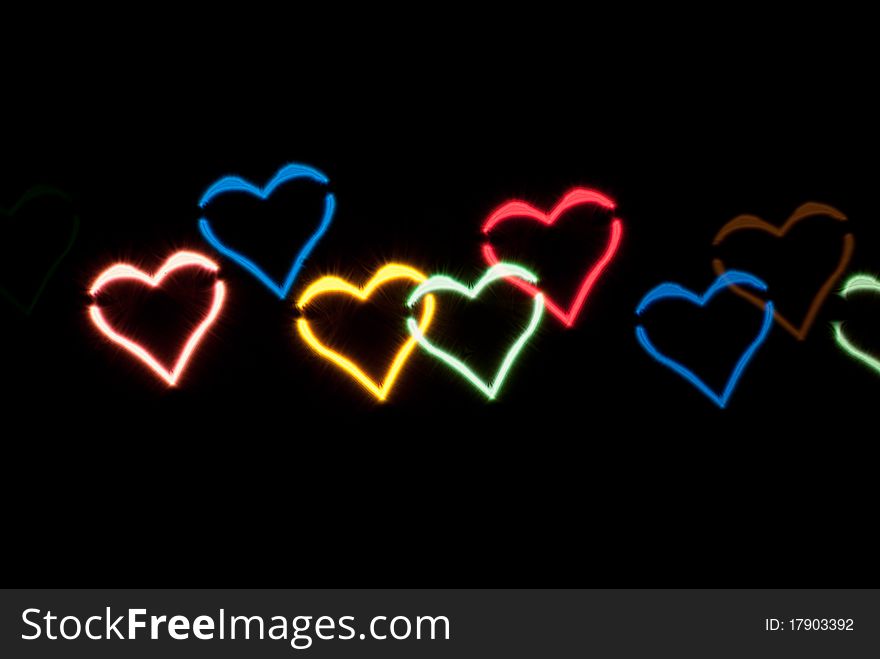 Light effect in the form of hearts on black background. Light effect in the form of hearts on black background