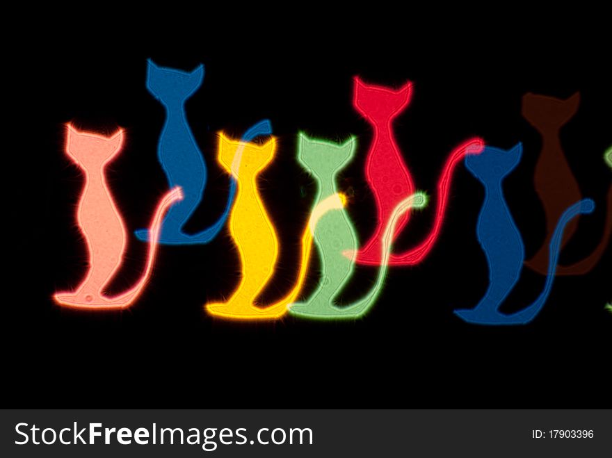 Light effect in the form of cats on black background. Light effect in the form of cats on black background