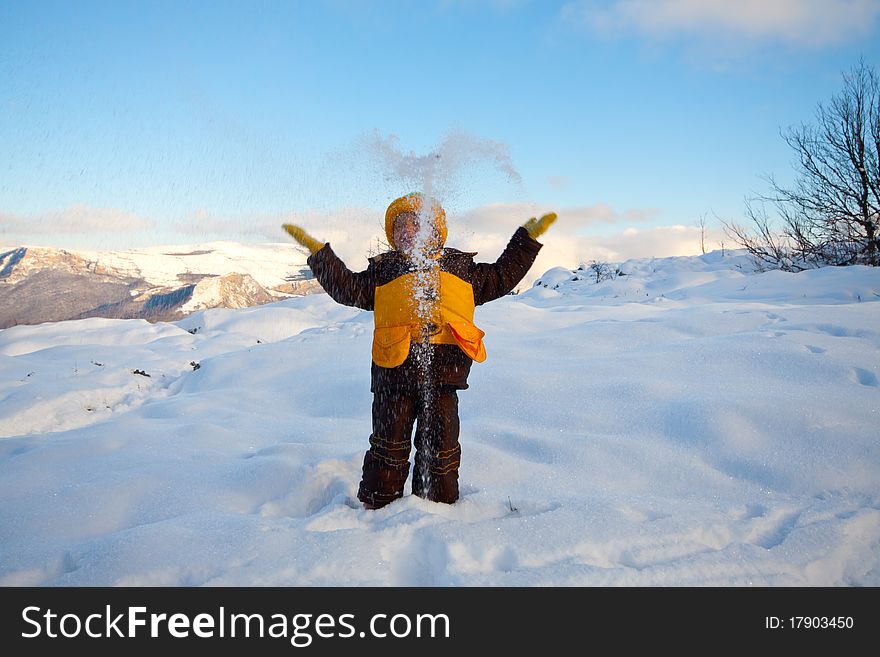 Happy little kid is playing in snow, good winter weather. Happy little kid is playing in snow, good winter weather