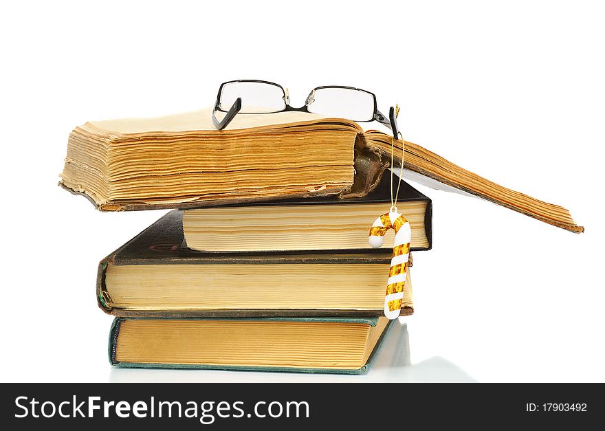 Heap of books and glasses on it, isolated on white