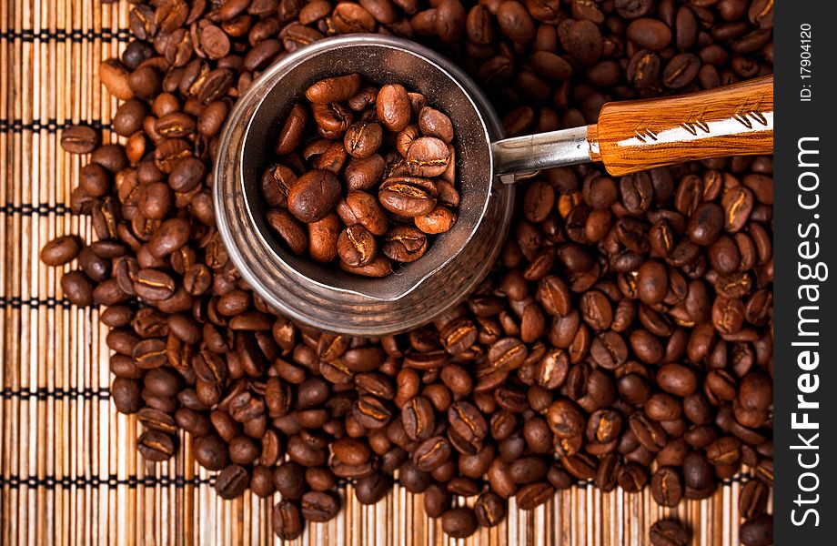 Roasted coffee beans and coffee pot