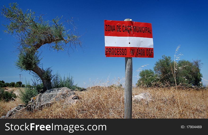 White an red sign under blus sky in burned fields by the sun. White an red sign under blus sky in burned fields by the sun