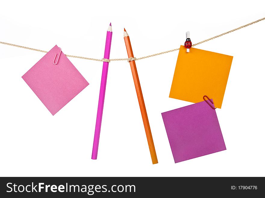 Note papers and colorful pencils on the rope isolated on white