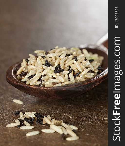 Mixed rice on wooden spoon selective focus