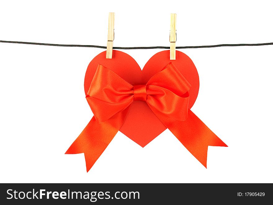 Heart with a bow on the clothesline on a white background