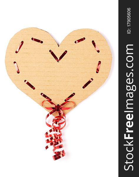 Cardboard heart with a red ribbon on white background