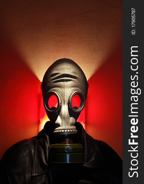 Man wearing gas mask on red background with lighting effect. Man wearing gas mask on red background with lighting effect