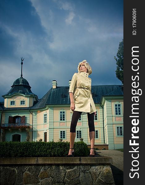 Attractive blond girl standing in castle park. Attractive blond girl standing in castle park