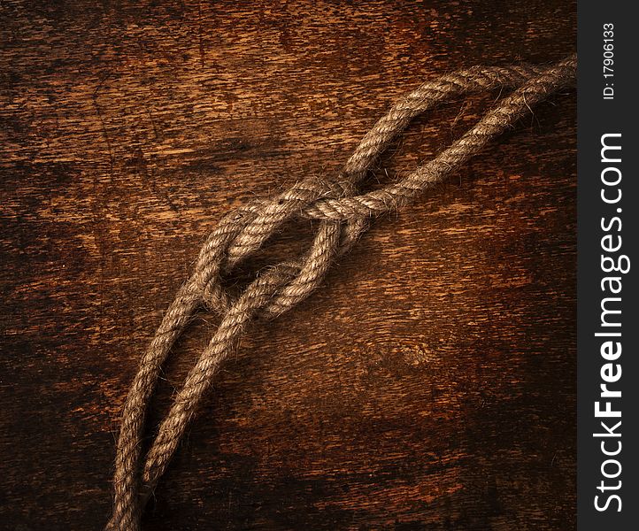 Rope on dirty wood background