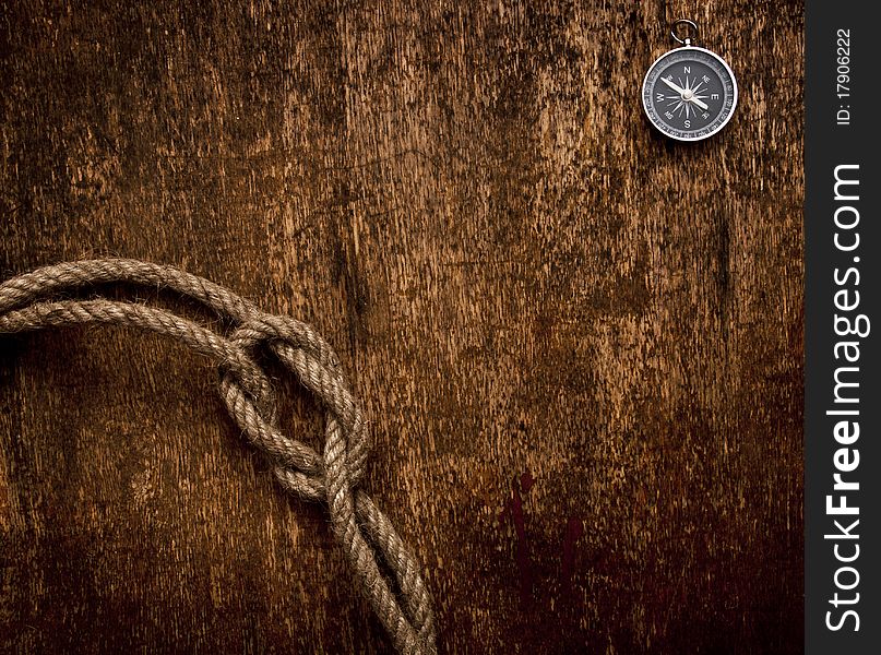 Compass and rope on grunge background