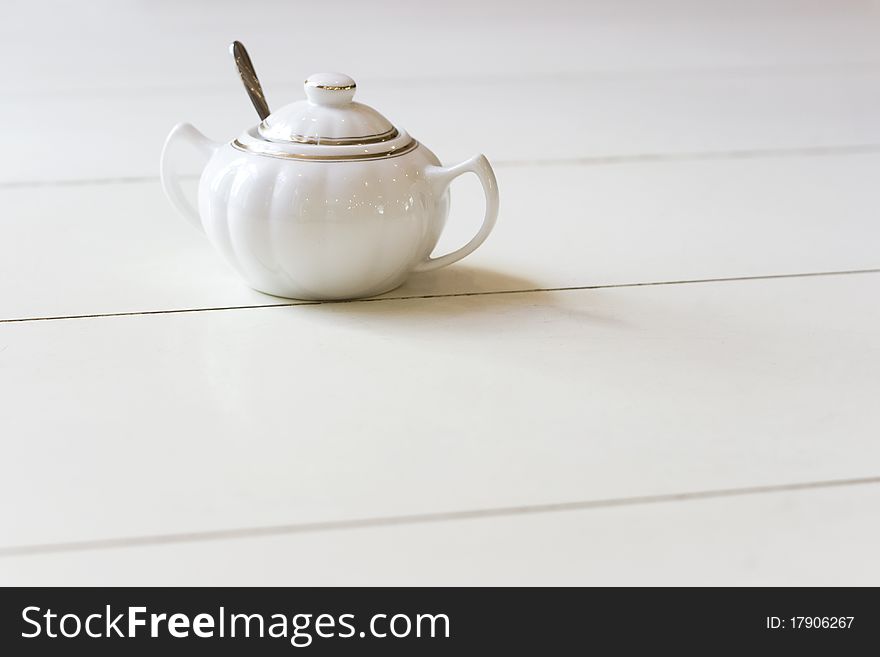 Vintage style Chinese porcelain sugar bowl on table in retro cafe. Vintage style Chinese porcelain sugar bowl on table in retro cafe.