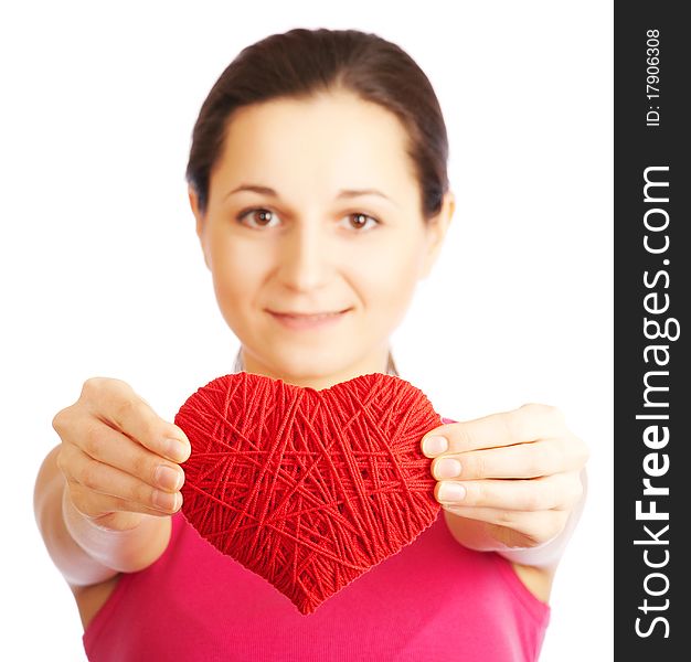 Beautiful girl with a heart in his hands on a white background