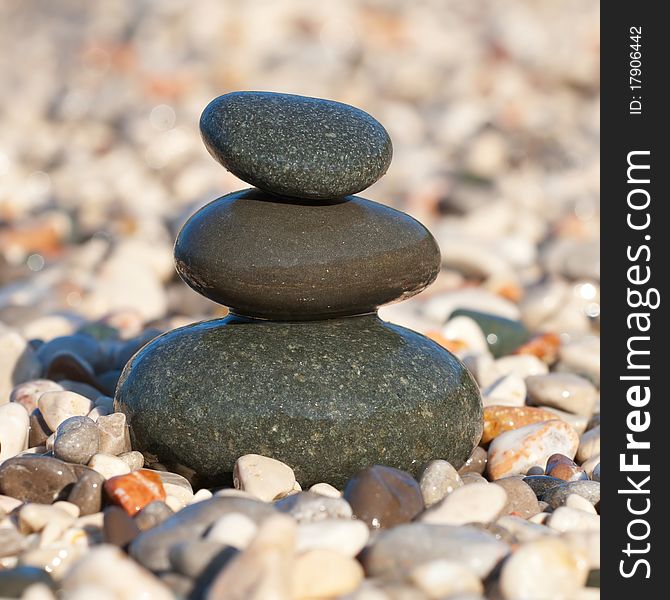 Pyramid made with wet pebble stones on the sea beach