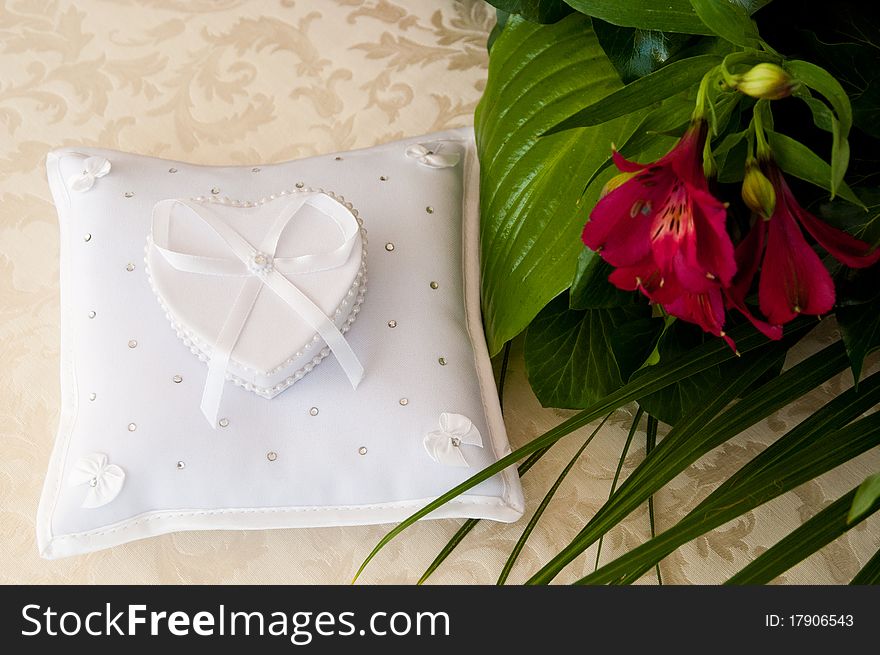 Casket in the shape of a heart on the pillow