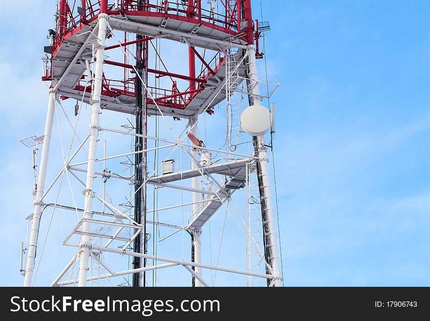 Telecommunication tower agains blue sky background