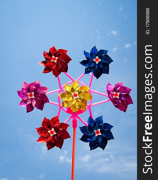 Colorful pinwheel agains clear blue sky