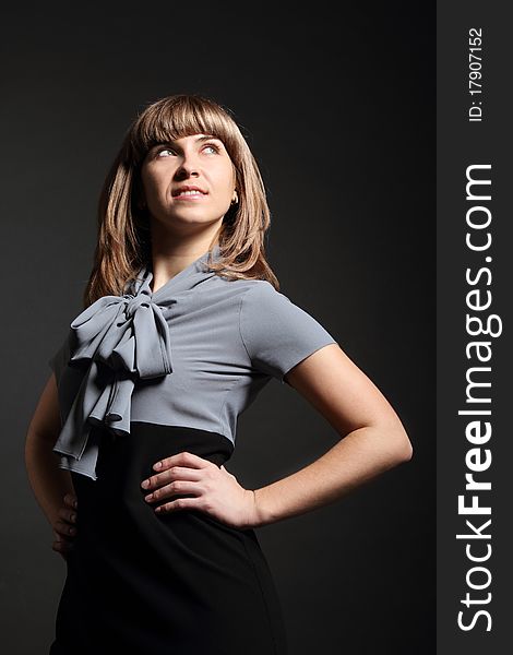 Young business woman in grey and black dress