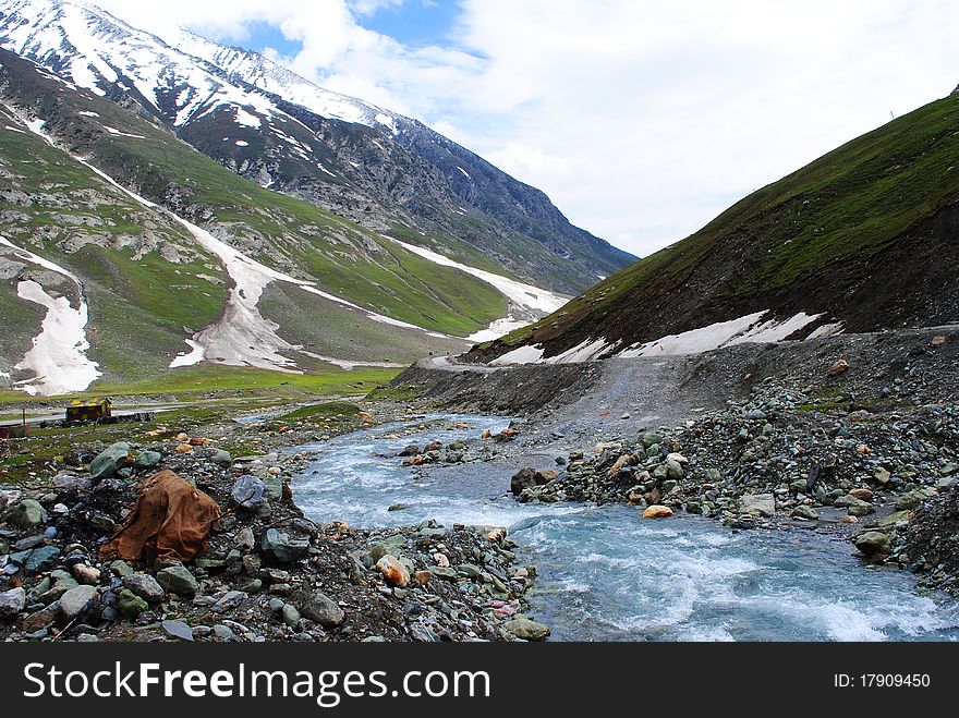 A beautiful scene with glaciers and snow peaks with a stream water flowing through. A beautiful scene with glaciers and snow peaks with a stream water flowing through.