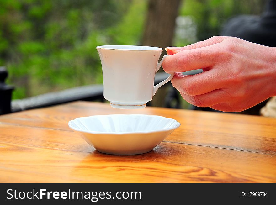 A hand holds a coffee cup. A hand holds a coffee cup