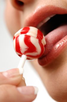 Girl Licking A Lollipop Royalty Free Stock Photo