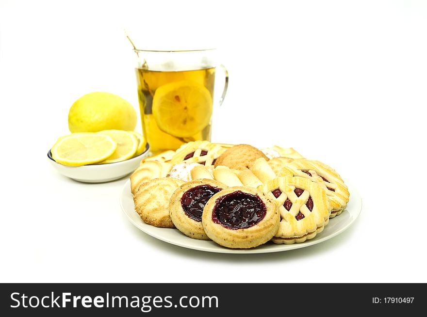Cookies on a plate with lemon tea on a white background