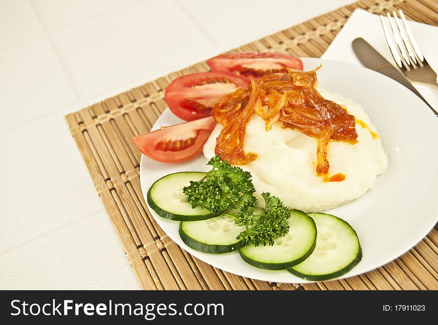 Mashed potatoes with vegetables and sause on a table