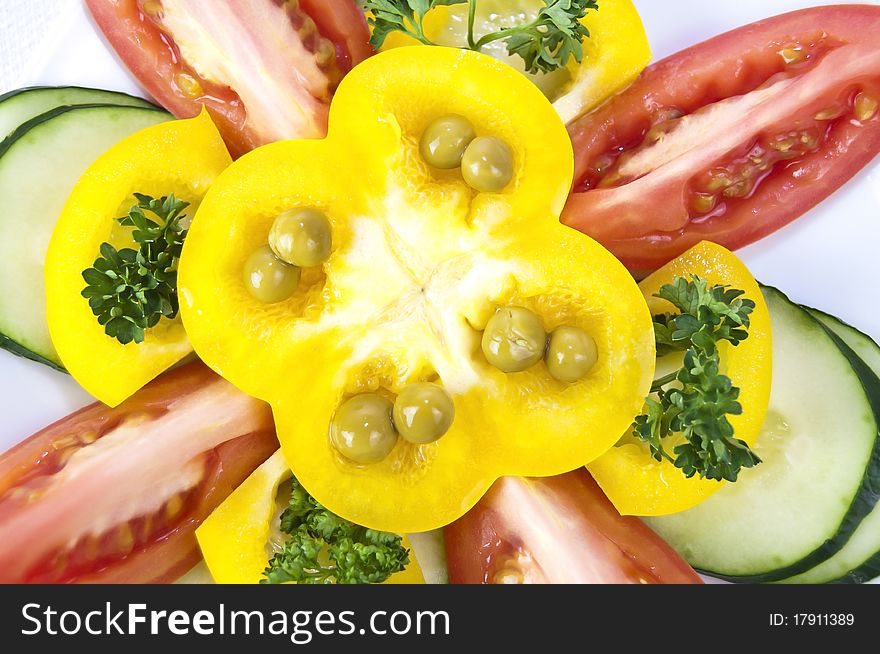 Colored raw vegetables for salad in plate on a table