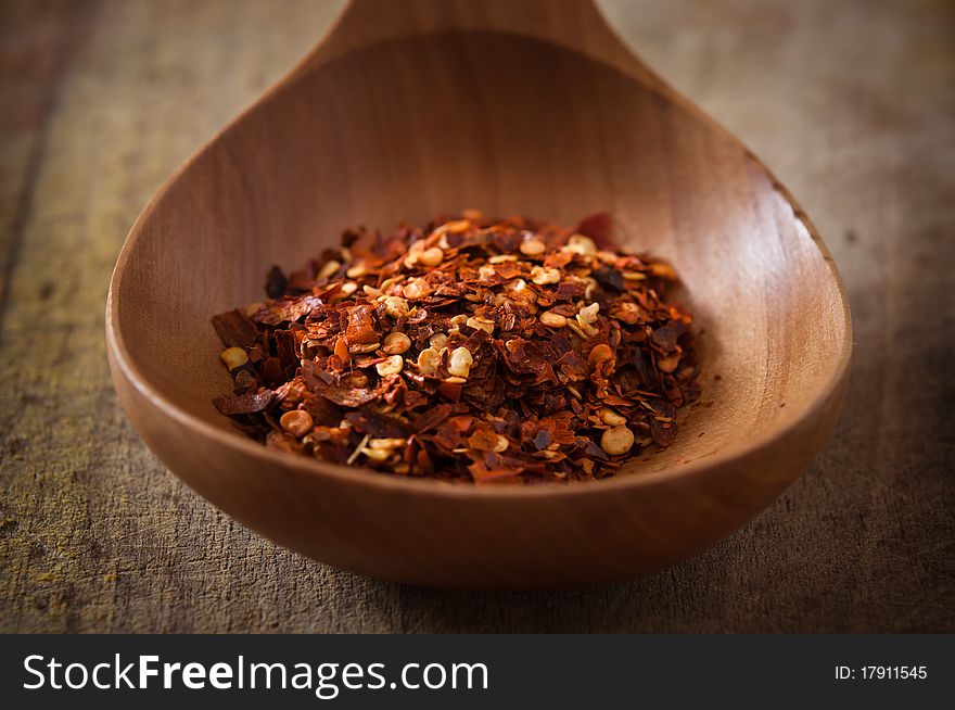 Chili pepper on wooden spoon,series