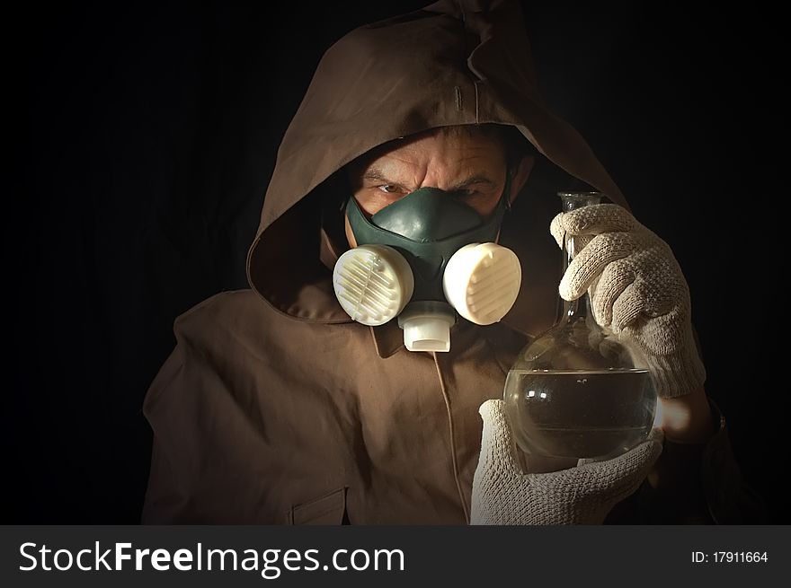 Man weared Soviet gas mask with lab flask. Man weared Soviet gas mask with lab flask