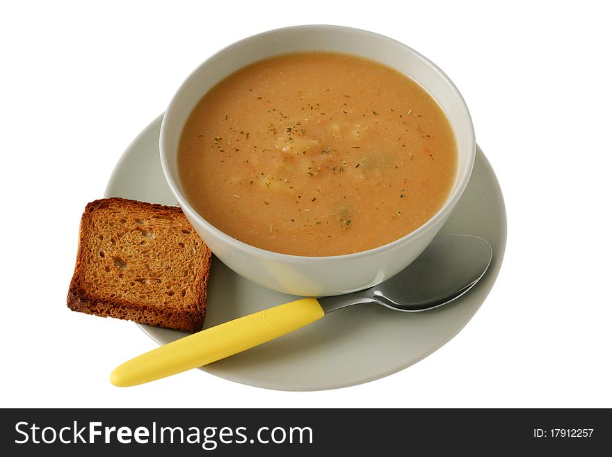 Vegetable soup with toast and spoon