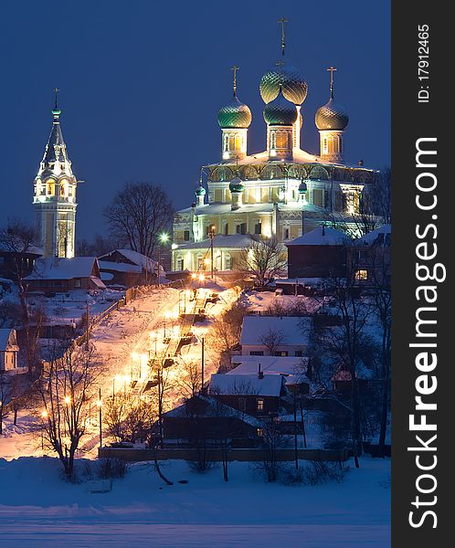 Illuminated church on high river coast