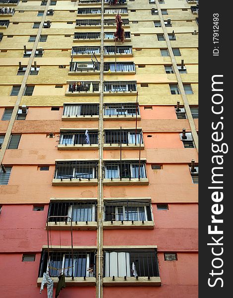 It is the public residential building in downtown of Hong Kong. It is in orange and yellow color. It is the public residential building in downtown of Hong Kong. It is in orange and yellow color.