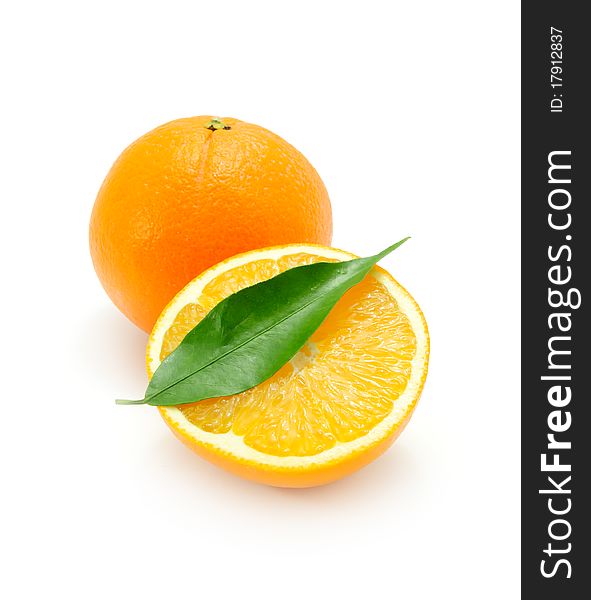 Juicy oranges with a green leaf isolated on a white background. Juicy oranges with a green leaf isolated on a white background