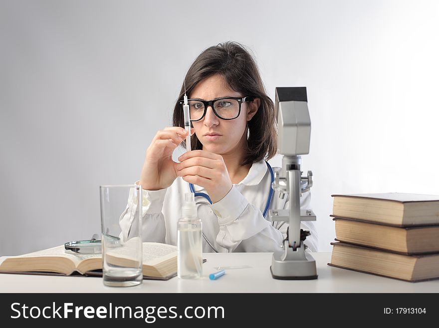 Young scientist examining some substances in a laboratory. Young scientist examining some substances in a laboratory