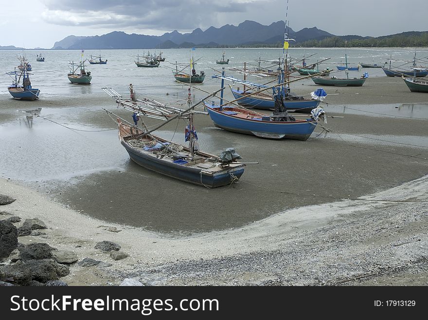 Cuttlefish boats on the beach in rainy day in Thailand. Cuttlefish boats on the beach in rainy day in Thailand.