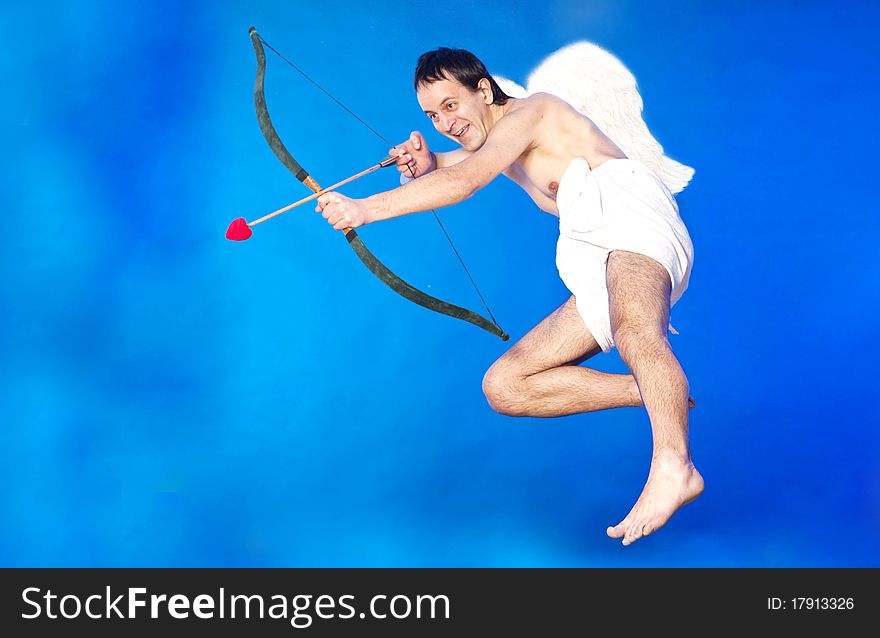 Cupid aiming with his hearth shaped arrow. Cupid aiming with his hearth shaped arrow