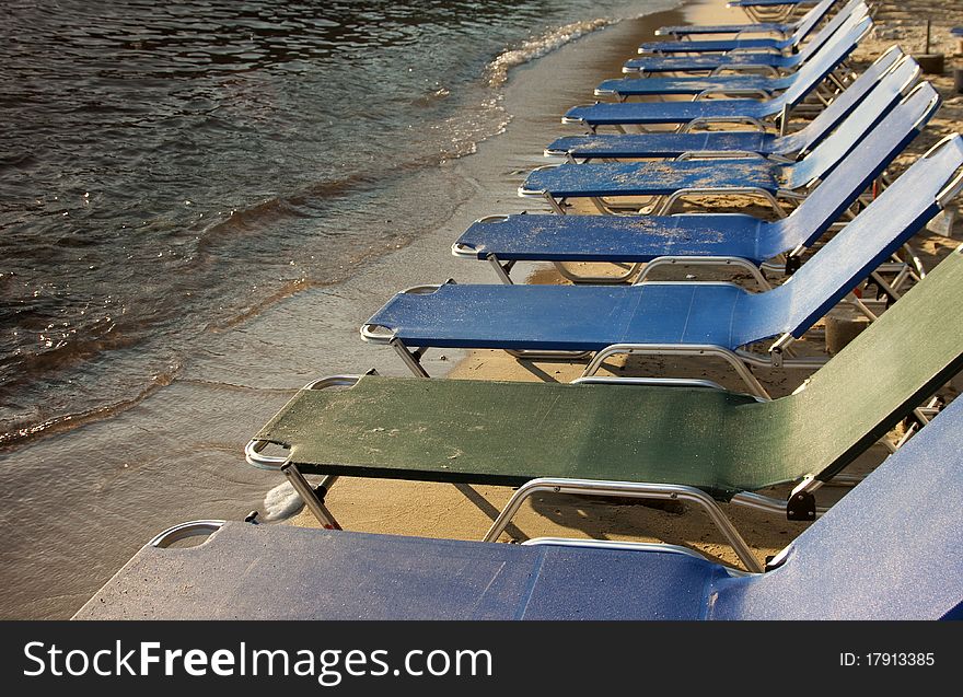 Row of beach chairs near seashore