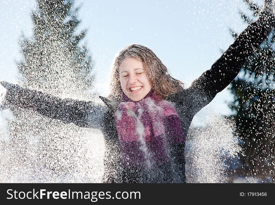 Happy young woman in heavy snowfall
