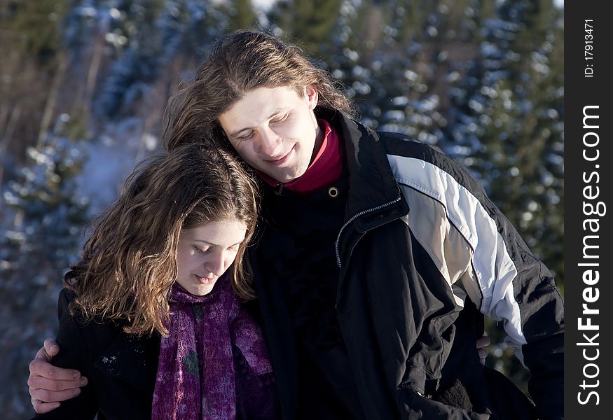 Happy young couple outdoors playing in snow