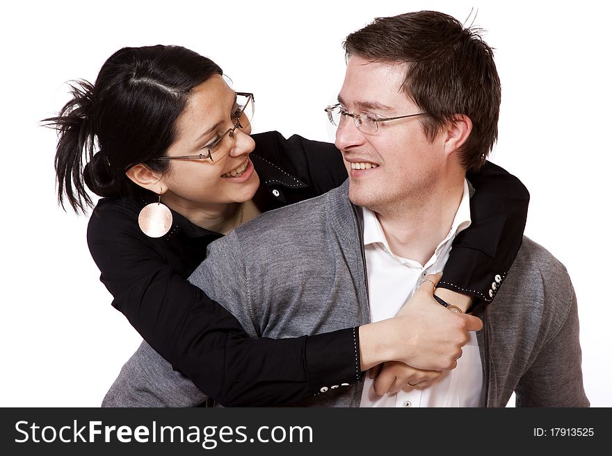 Happy casual couple isolated on white - man piggybacking his girlfriend. Happy casual couple isolated on white - man piggybacking his girlfriend