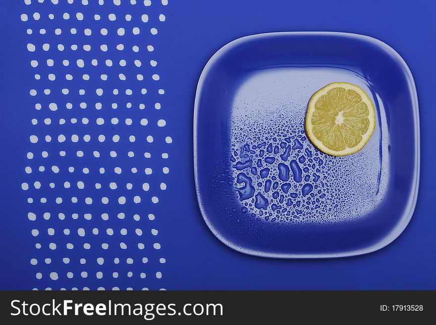 Fresh lemon on the blue plate. Vegetarian food