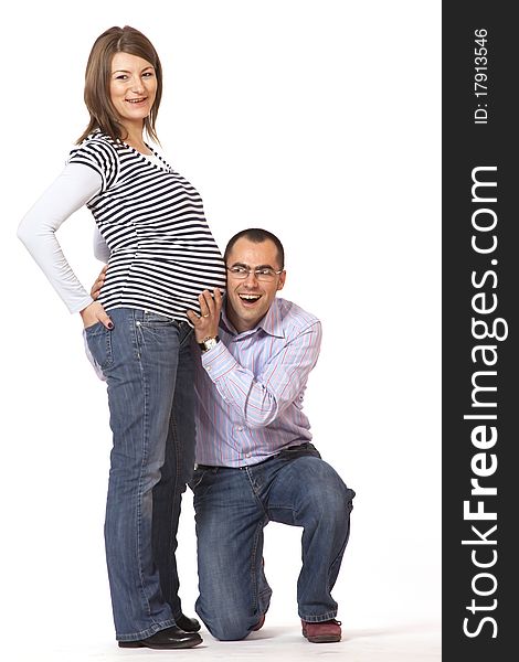 Happy young man and his pregnant wife isolated on white