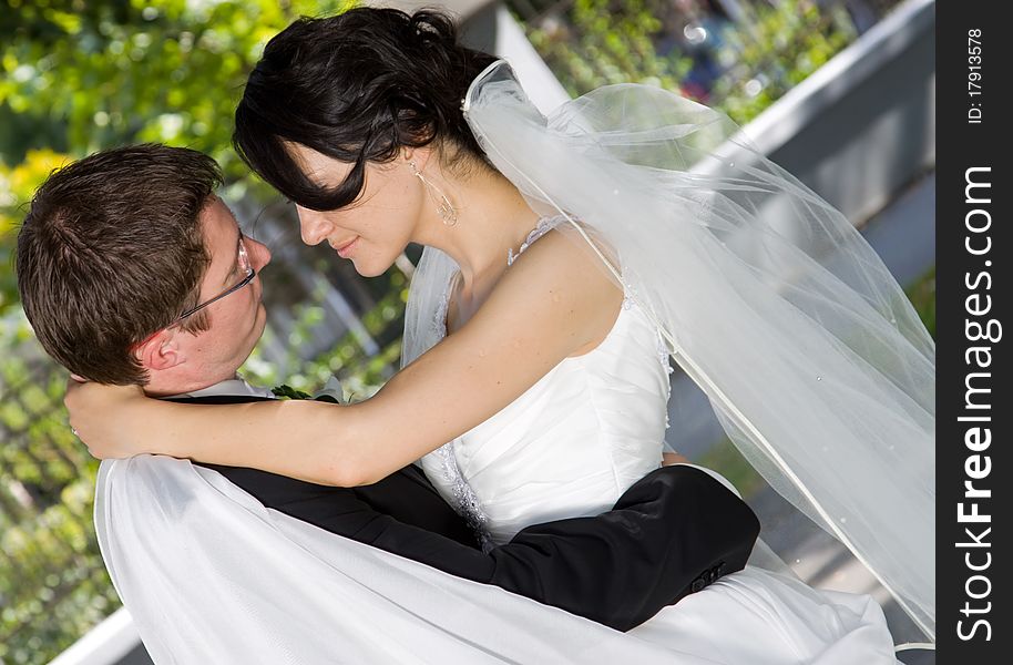 Bride and groom in green park