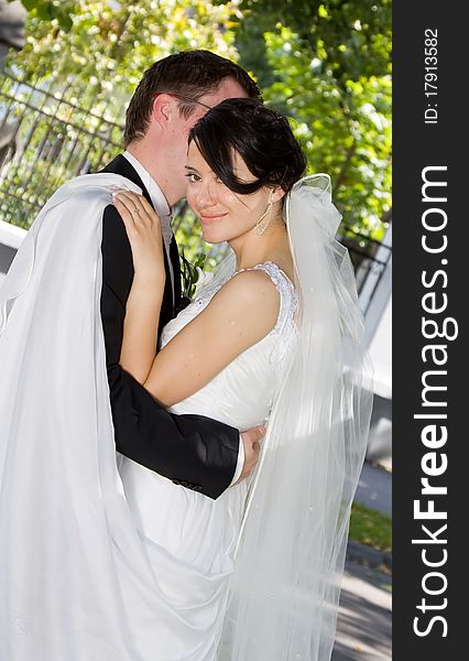 Bride and groom in green park