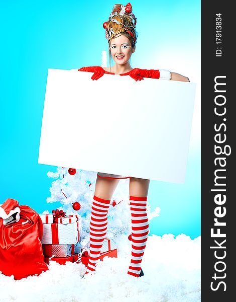 Beautiful young woman in Santa Claus clothes over Christmas background. Beautiful young woman in Santa Claus clothes over Christmas background.