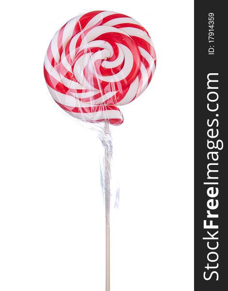 Lovely lollipop with red and white stripes on white background. Lovely lollipop with red and white stripes on white background
