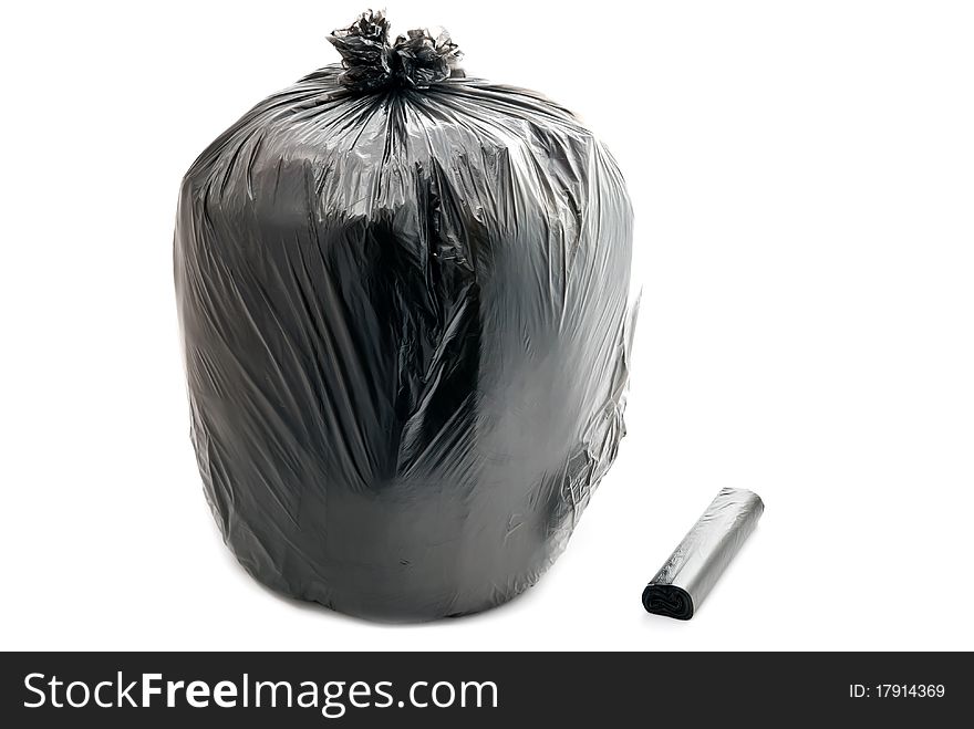 Tied black garbage bag isolated on a white background.