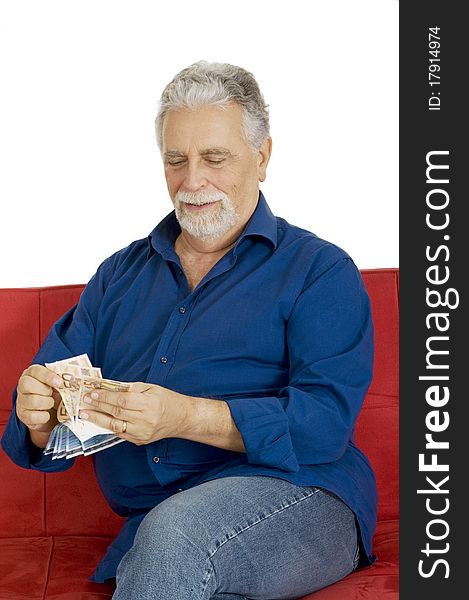 Elderly man on the couch with money in hand in a white background