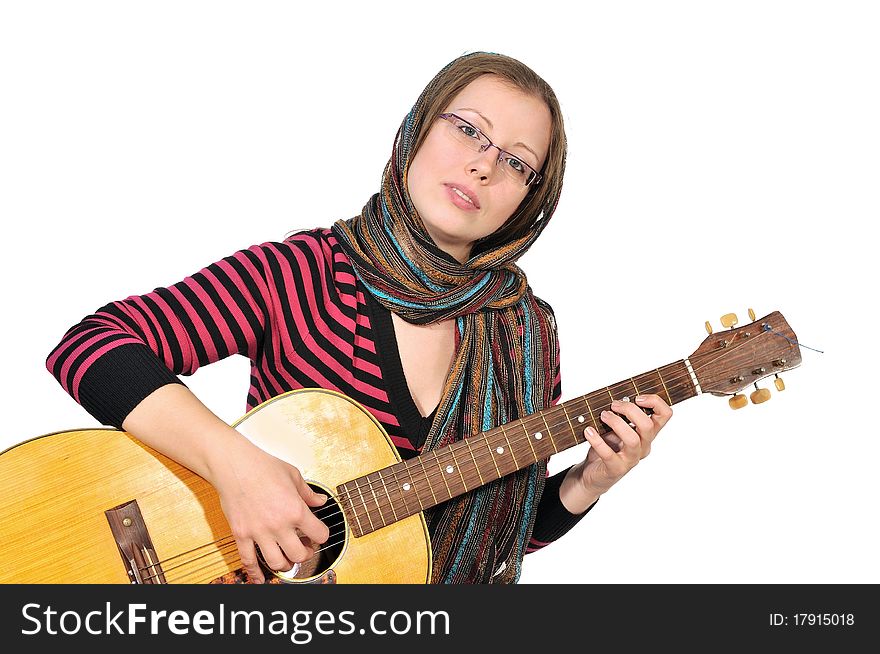 A girl plays a sad tune on the six-string guitar. A girl plays a sad tune on the six-string guitar